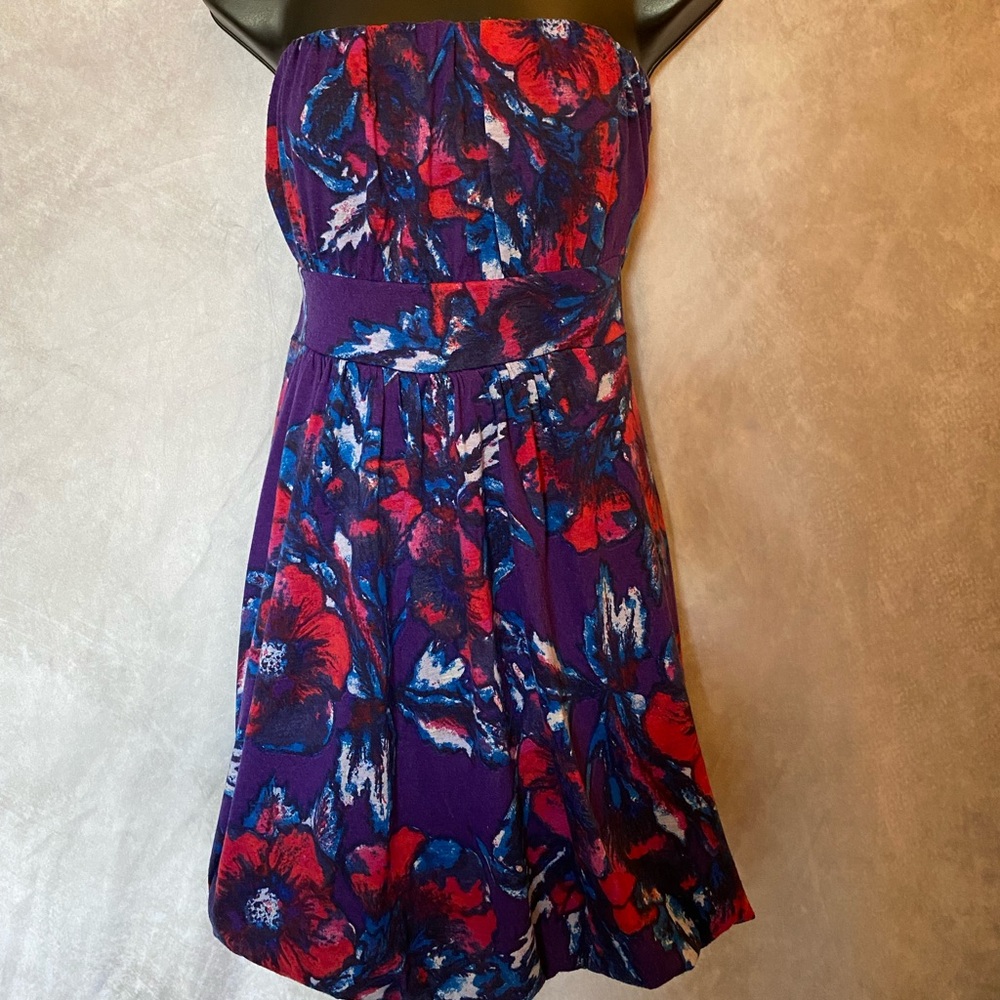 It is a beautiful, comfortable, fun, strapless dress, over the knee.